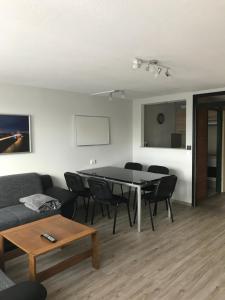 a living room with a table and chairs and a couch at Ferienwohnung im Terrassenpark Sasbachwalden in Brandmatt