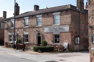 a brick building with tables and chairs in front of it at The Castle Inn in Harrogate