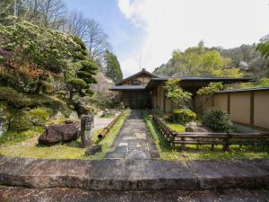 a building with two benches and a path leading to it at Ryori Ryokan Shikanoyu in Ena +48 photos