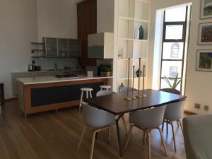 a kitchen and dining room with a table and chairs at 2 Bedroom Louise in Mutual Heights in Cape Town