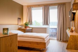 A bed or beds in a room at Hotel z'Leithen