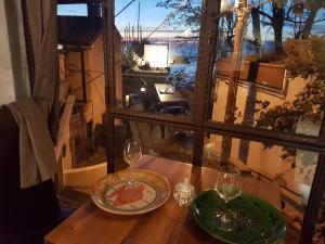 a table with two glasses and a plate on it at Hotel Mignon in Trieste