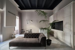a living room with a couch and a plant at Saint Paul Apartment in Valletta
