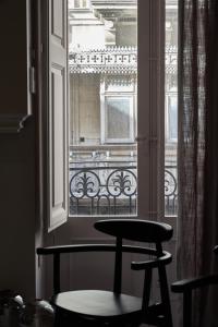a window with a chair in front of a balcony at Saint Paul Apartment in Valletta