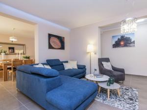 a living room with a blue couch and a table at Lovely Villa in Debeljak with Heated Private Pool in Debeljak