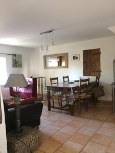 a living room with a couch and a table at L'Oustaou de Rose in Bonnieux