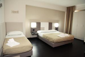 Postel nebo postele na pokoji v ubytování Hotel Sogni D'Oro Airport