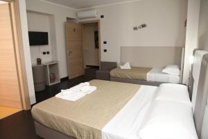 Postel nebo postele na pokoji v ubytování Hotel Sogni D'Oro Airport