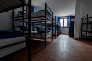 a room with several bunk beds in a room at Albergue Turístico Tierras Altas in Fuentes de Magaña