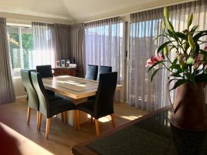 a dining room with a table and chairs at Middleton Bay Retreat in Albany