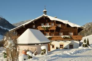 a chalet in the snow with snow at Brandstatthof Leogang in Leogang