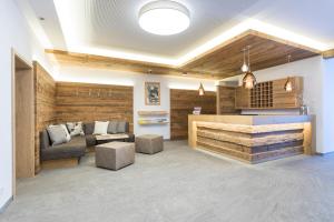 a living room with a couch and a table at OFENTÜRL alpine living in Flachau +49 photos