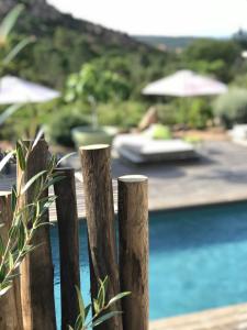 a wooden fence in front of a pool at Hotel Les Chambres de Mila Bonifacio in Bonifacio