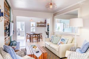 a living room with a couch and a table at Mylas Cottage in Swakopmund
