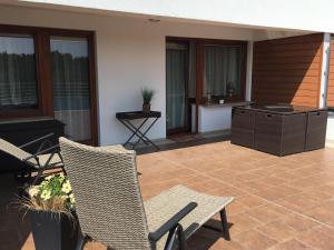a patio with chairs and a grill and a table at APARTAMENT 345 w Domu Zdrojowym - Jastarnia in Jastarnia
