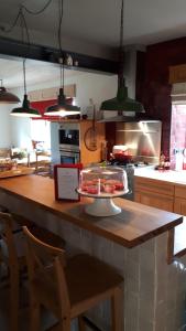 a kitchen with a counter with a cake on a table at les maisons blanches in Weris