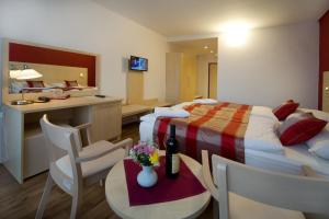 pokój hotelowy z łóżkiem, stołem i krzesłami w obiekcie Hotel Krystal w Pradze
