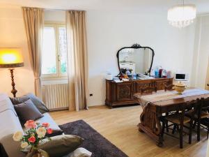 a living room with a table and a mirror at BB Villa Magda in Novafeltria +43 photos