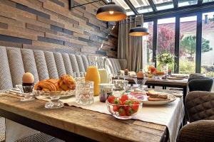 a table with food and eggs on top of it at La Cotentine Maison d'Hôtes in Saint-Pair-sur-Mer