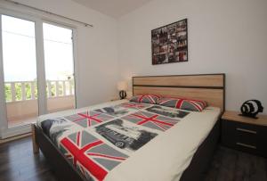 a bedroom with a bed and a window with a view at Villa Guliver in Slatine