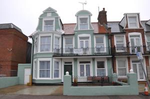 a large house with a balcony on top of it at Victoria Villa Guesthouse in Clacton-on-Sea