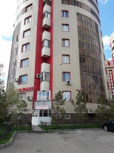 a tall building with a red and white at Prospect in Astana