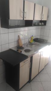 a kitchen with a black counter top with a sink at Apartment Angelina in Risan