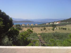 a view of a field and a body of water at KOUVERTA APARTMENTS in Ermioni