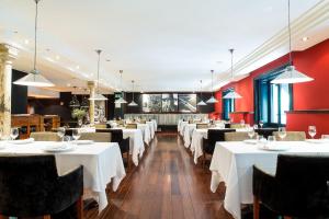 a dining room with white tables and chairs at Hotel 1898 in Barcelona