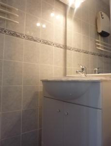 a white bathroom with a sink and a counter at Appart'Hôtel Les Rochers in Auriol +97 photos