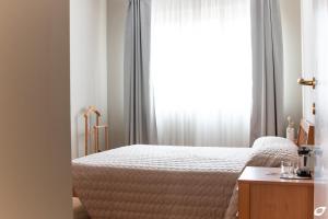 - une chambre avec un lit et une fenêtre dans l'établissement 2-bedroom apt, with balcony & aircondition - 50 m from the beach, à Marina di Pietrasanta