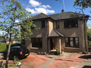 a house with a car parked in front of it at Arron House in Hamilton