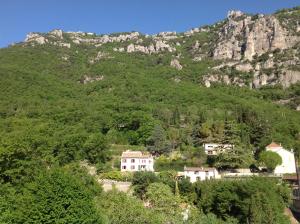 a village in front of a mountain at La cigale in Gourdon