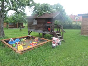 un arenero de juguete frente a una casa de juegos en Mazurskie Wzgórze, en Rydzewo
