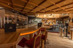 a kitchen with a bar and a dining room at Hotel Sonnenhof in Going