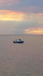 two people on a boat in the water at sunset at Freo for Two in Fremantle