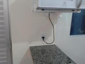 a room with a counter and a tv on a wall at Lacqua DiROMA V in Caldas Novas