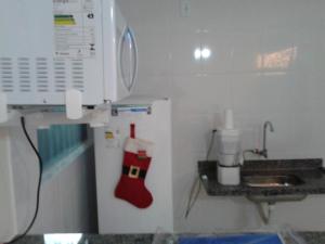 a kitchen with a refrigerator with a christmas stocking on it at Lacqua DiROMA V in Caldas Novas