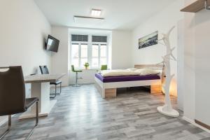 a bedroom with a bed and a desk and a desk at Allram "TopSleep" 24 hours checkin in Waidhofen an der Thaya