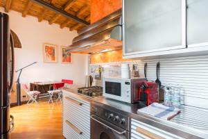 a kitchen with a microwave and a stove top oven at Brera 20 in Milan