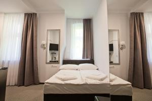 Posteľ alebo postele v izbe v ubytovaní R&B APARTMENTS POZNAŃ