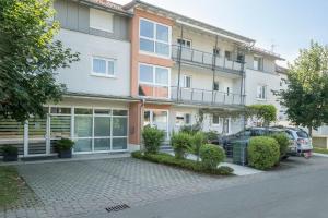 a building with a car parked in front of it at Ferienwohnung Schwedi in Langenargen