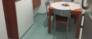 a kitchen with a table and a table and chairs at Joseph Apartment in San Benedetto del Tronto