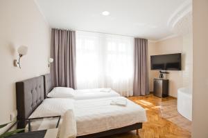 Posteľ alebo postele v izbe v ubytovaní R&B APARTMENTS POZNAŃ