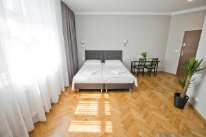 Posteľ alebo postele v izbe v ubytovaní R&B APARTMENTS POZNAŃ