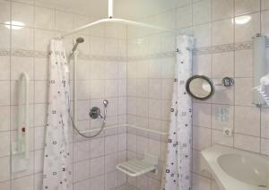a bathroom with a shower and a sink at Smarthotel Gallmersgarten in Gallmersgarten +22 photos