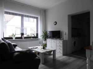 a living room with a couch and a tv at Ferienwohnung Riemeyer in Lutherstadt Wittenberg