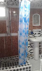 a shower curtain in a bathroom with a sink at Ilgar's Hostel in Sheki +46 photos