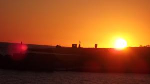 a sunset with the sun setting in the distance at Hotel Giglio in Lampedusa