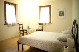 Un pat sau paturi într-o cameră la B&B Al Sole Di Cavessago